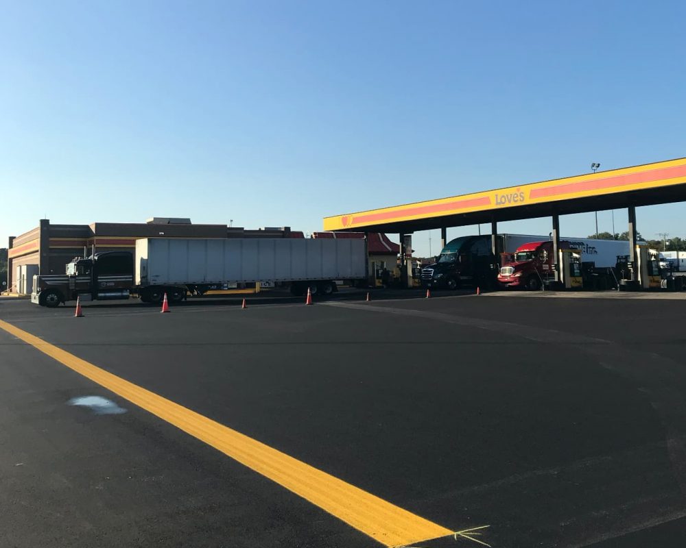 yellow lines painted by limitless paving and concrete for a gas station